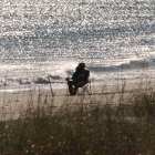 man sitting by beach